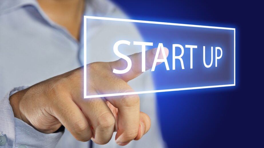 Hand pointing to a glowing "Start Up" sign, representing startup evaluation advice from My Last Startup